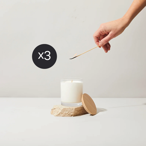 person lighting candle xchange candle x3