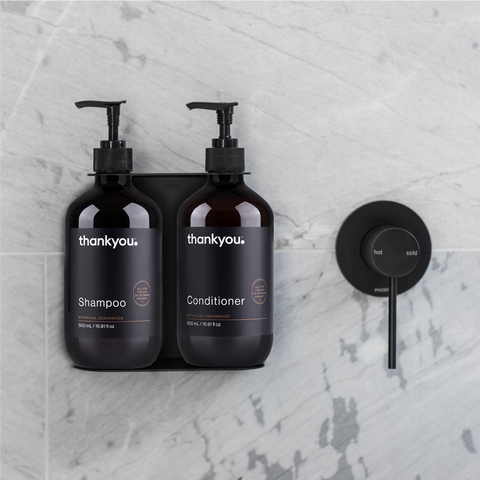 Dual soap dispenser containing Thankyou Amenities 500ml shampoo and conditioner